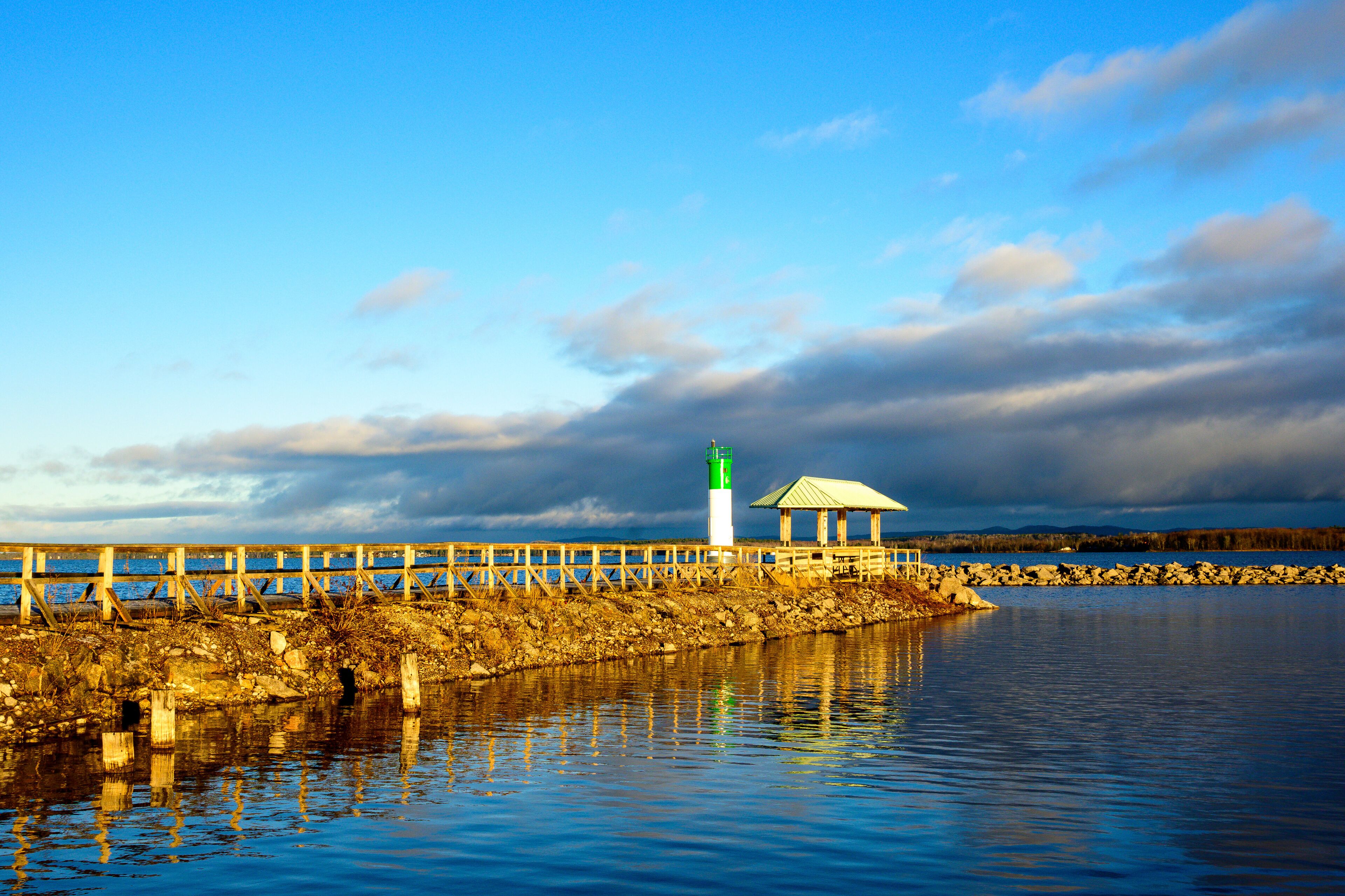 The Ottawa River in the first  light of the morning seen from the Pembroke Marina  in fall with a seawall and safe channel marker room for text	
