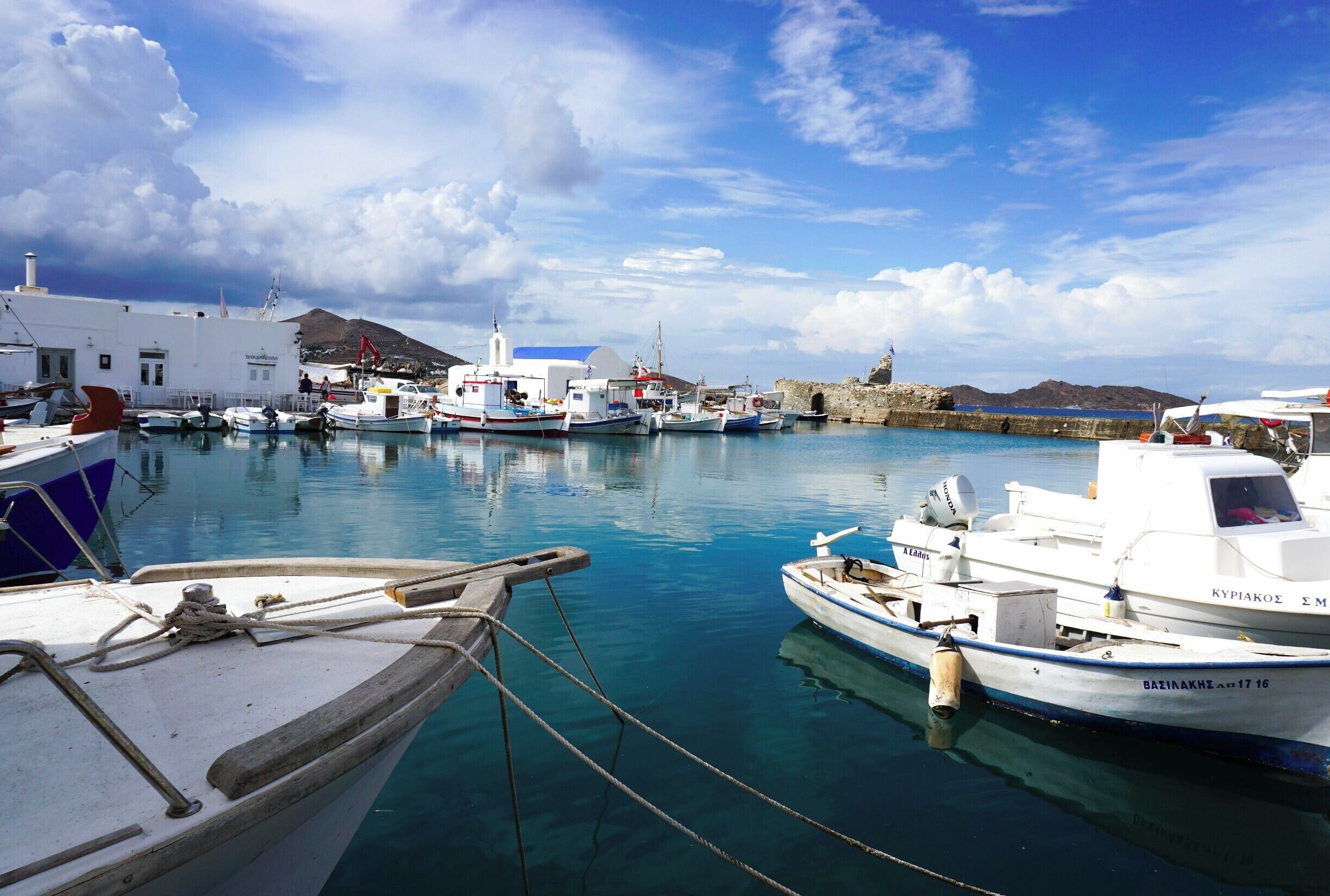 The dreamy fluffs of clouds, boats docked in the harbor and the quietness of an early morning in the Cyclades, this was my perfect moment in Paros, Greece. #Blue