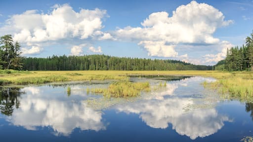 Blue mirror lake reflections of clouds and landscape. Sudbury, Ontario, Canada.