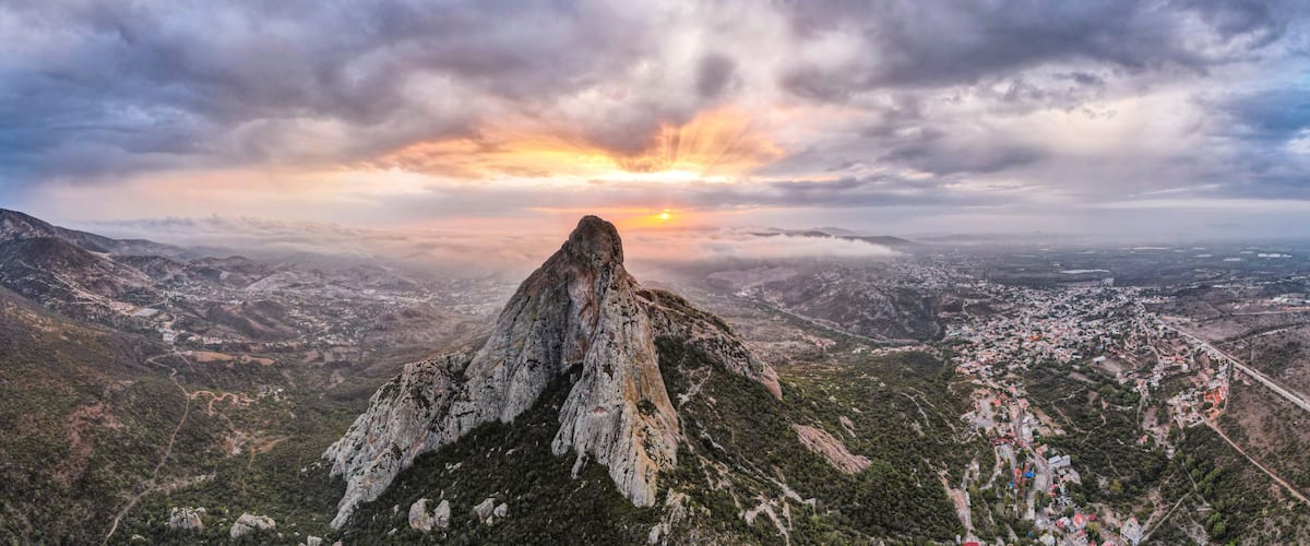 A mountain peak with a sunset in the background.