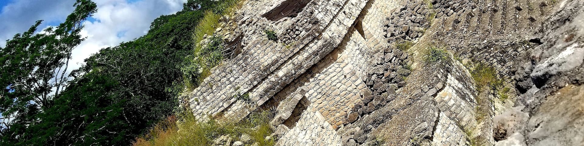 Ek Balam, now a protected ecological site in Mexico, was a predominant Mayan city between 550 AD and 850 AD with 12,000 inhabitants. The Acropolis, formerly a place of knowledge and learning, shown in the distance, features 106 steps to its peak.