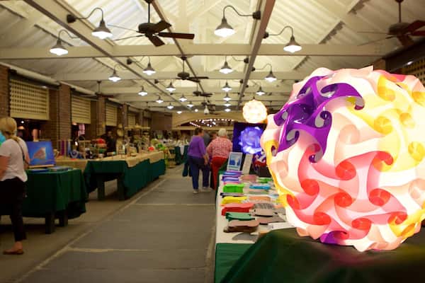 Charleston City Market which includes markets and interior views as well as a small group of people