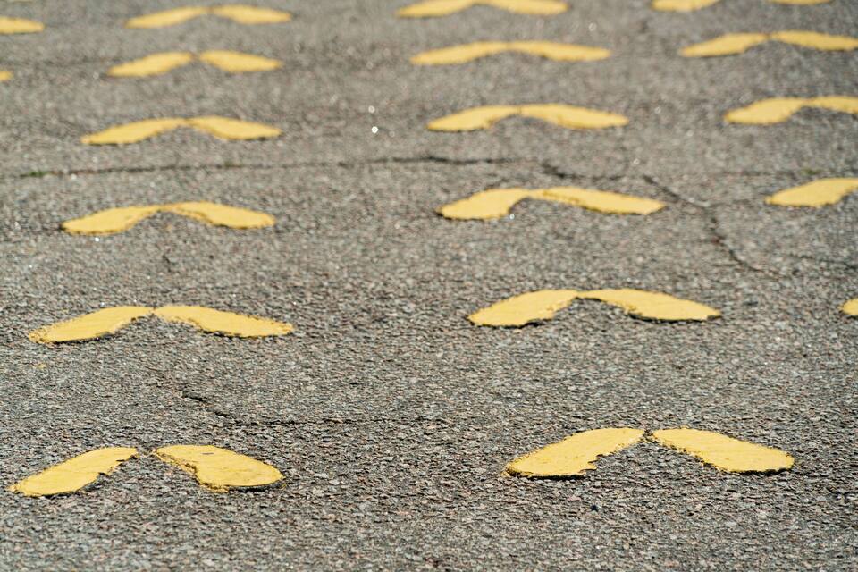 A close-up of a road with yellow chevron markings.