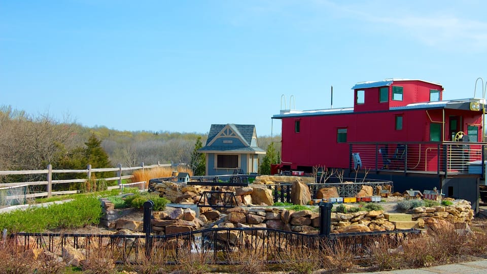 A red building with a blue roof, a small blue house, and a wooden fence.