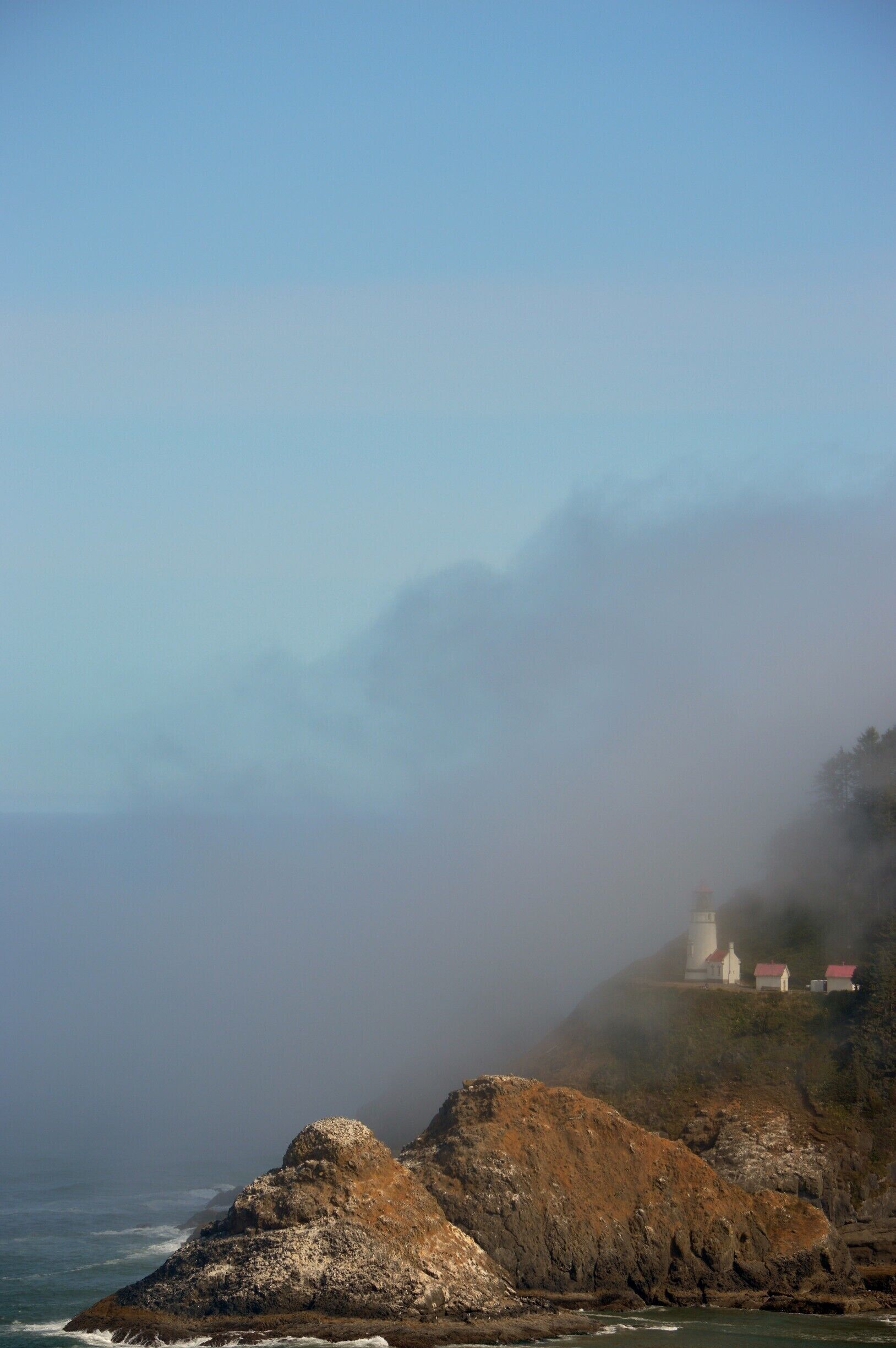 A beautiful morning with some sea mist still hanging around.Heceta Head Light is a lighthouse on the Oregon Coast 13 miles north of Florence, and 13 miles south of Yachats in the United States. It is located at Heceta Head Lighthouse State Scenic Viewpoint, a state park, midway up a 205-foot-tall headland. Built in 1894, the 56-foot-tall lighthouse shines a beam visible for 21 nautical miles making it the strongest light on the Oregon Coast. 
The light is maintained by the Oregon Parks and Recreation Department (OPRD), while the assistant lighthouse keepers' house, operated as a bed-and-breakfast inn, is maintained by the U.S. Forest Service. The lighthouse is 2 miles from Sea Lion Caves.
