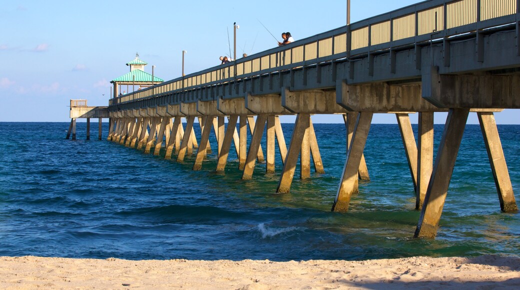 Visitors enjoy fishing off Deerfield Beach Pier in Deerfield Beach, Florida, with clear blue skies and calm waters