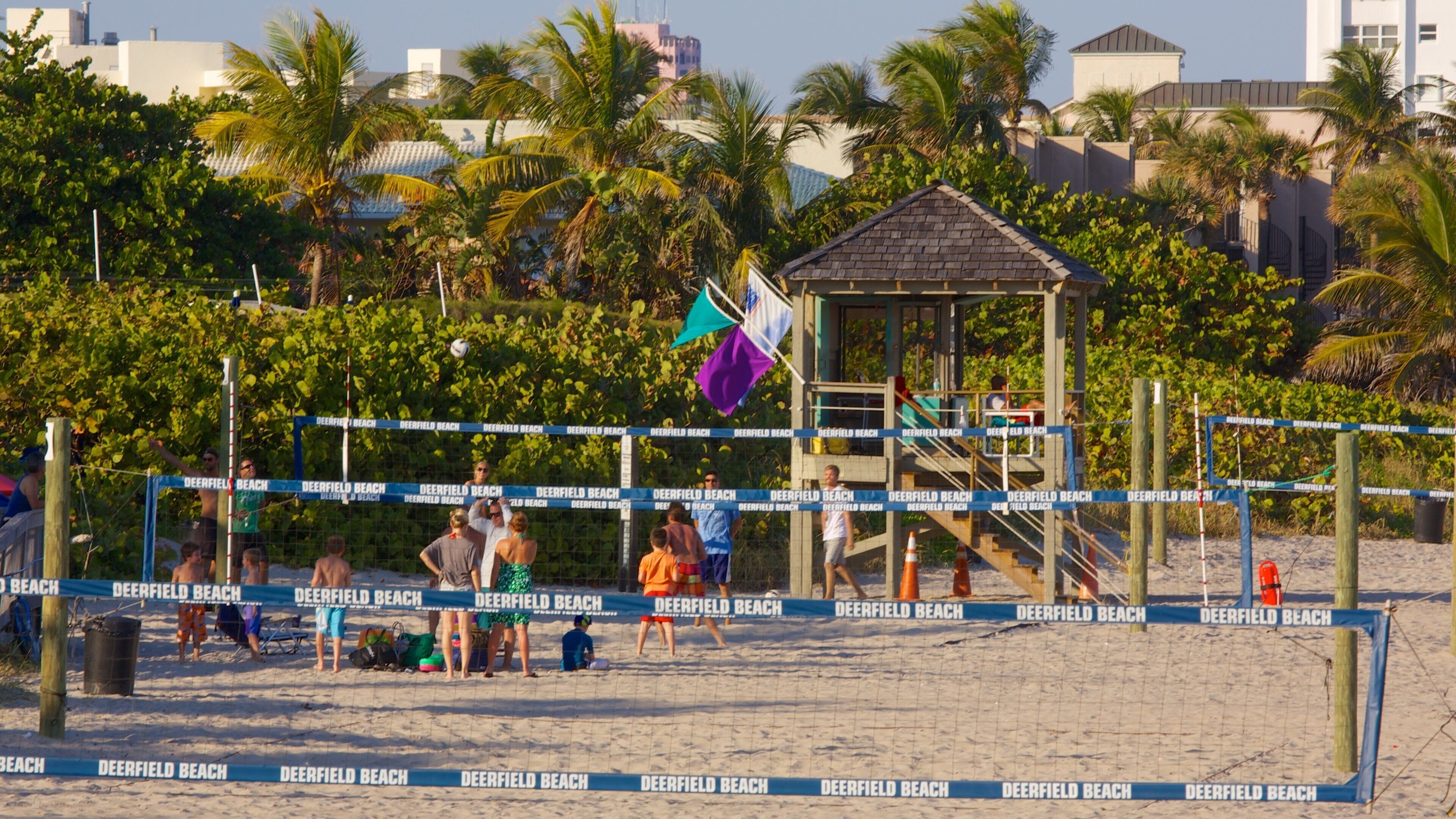 Busy beach scene at Deerfield Beach Pier showcasing families enjoying the sun in Florida
