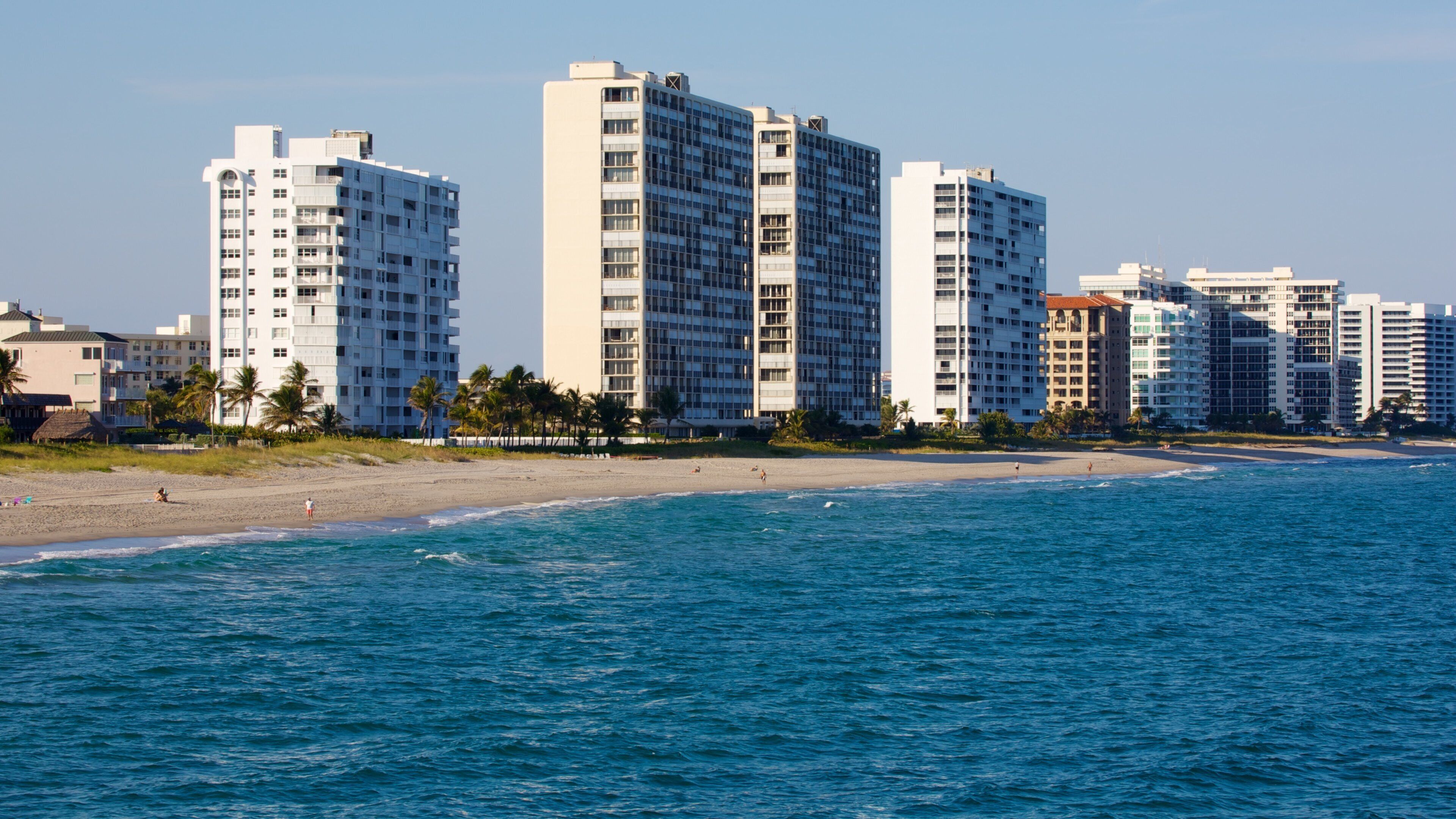 Serene view of Deerfield Beach Pier with clear skies and ocean waves in Florida