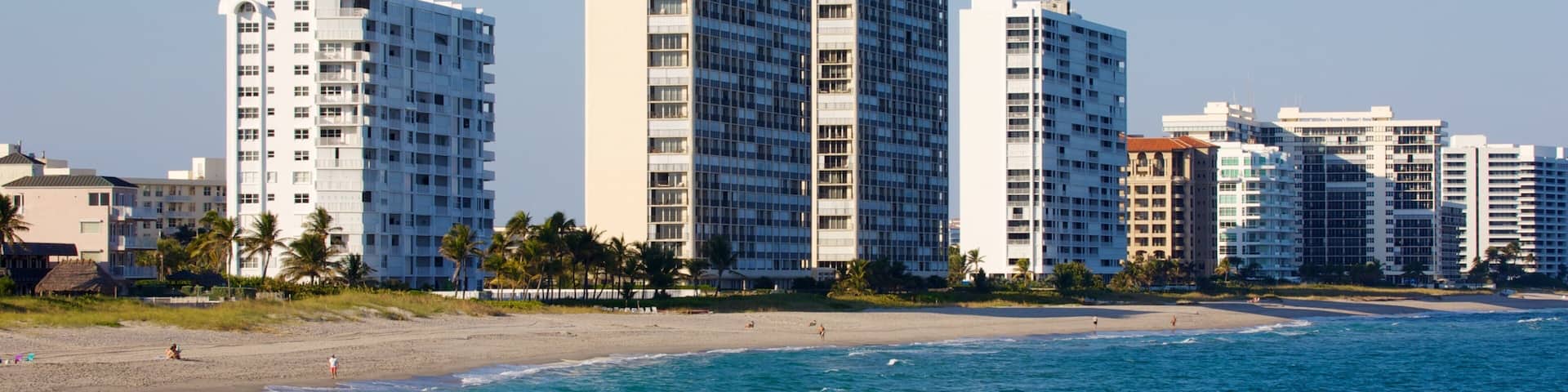 Serene view of Deerfield Beach Pier with clear skies and ocean waves in Florida