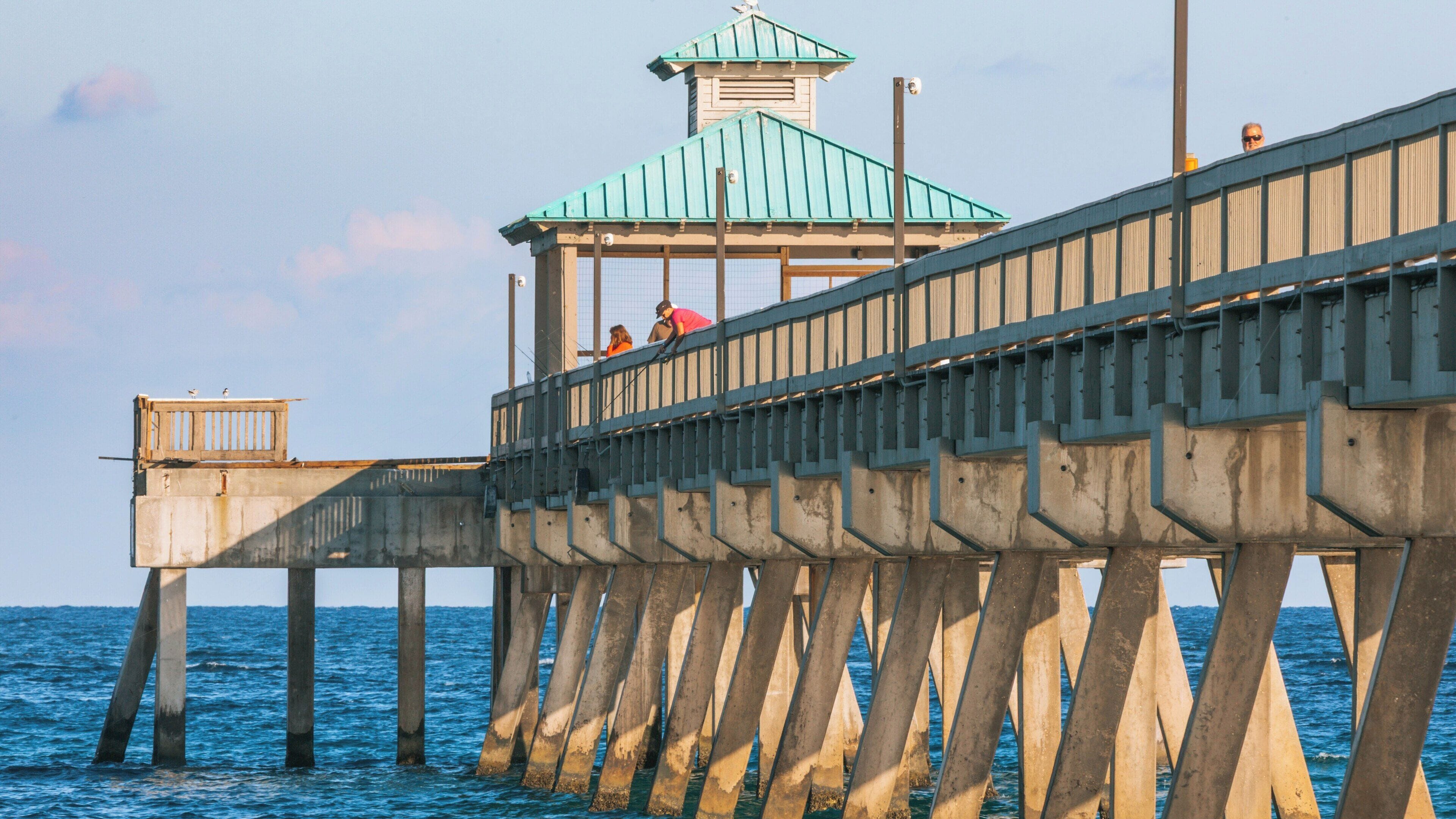 Deerfield Beach Pier stretches over the Atlantic Ocean, offering a serene spot for fishing and enjoying coastal views in Florida