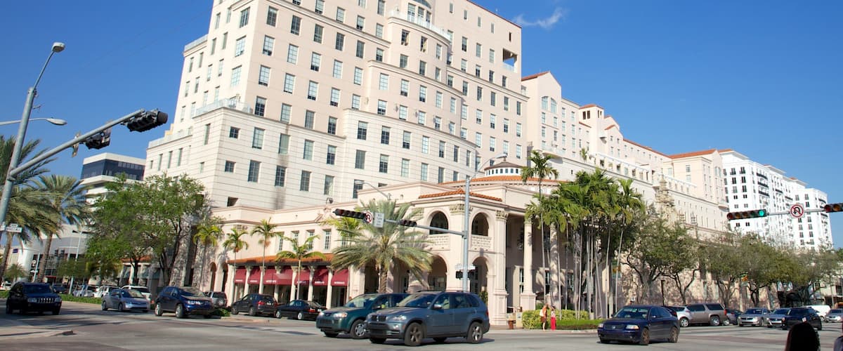 A large hotel with multiple stories and a red awning.