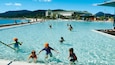 Cairns Esplanade showing a pool, a luxury hotel or resort and swimming