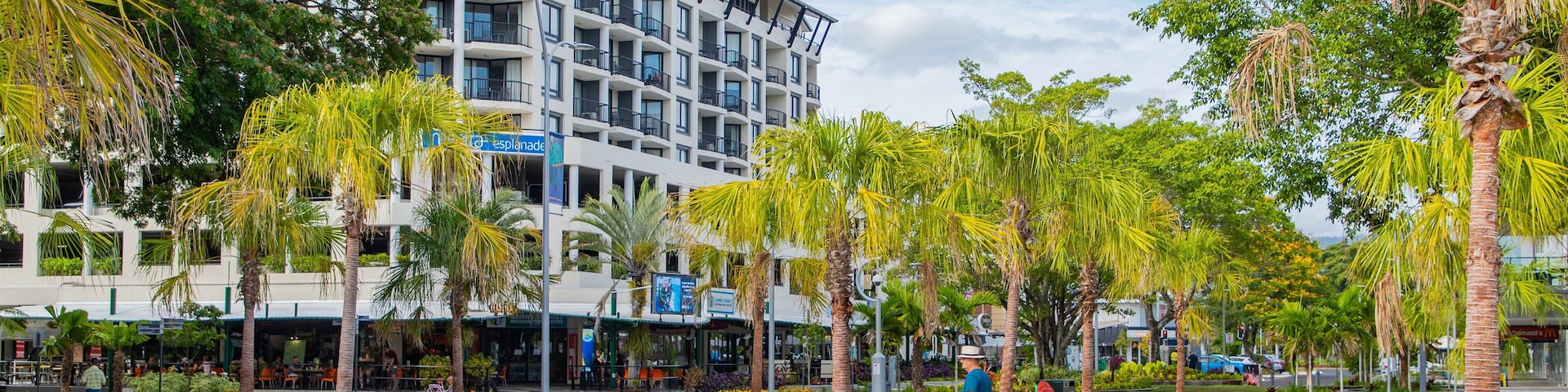 Cairns Esplanade which includes a square or plaza and street scenes as well as an individual male