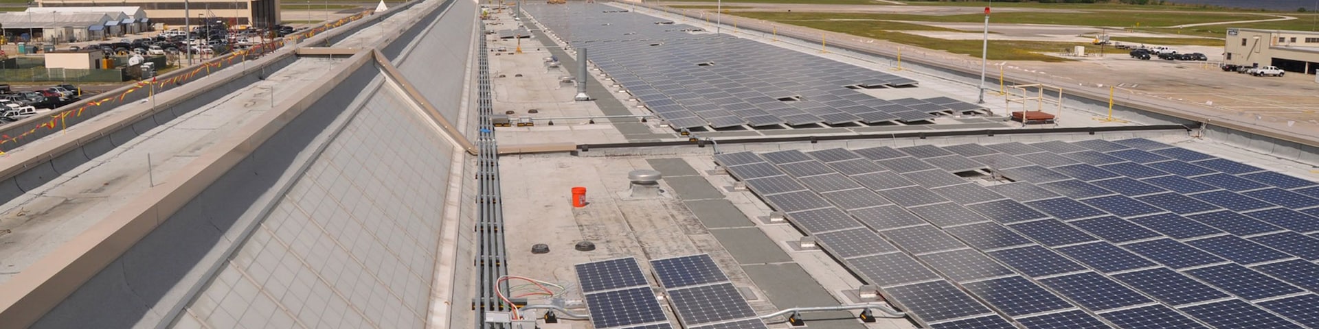 CPB1GP ) Some of the 2,534 solar photovoltaic (PV) panels installed on the roof of Naval Air Station Jacksonville's Hangar 1122 to help reduce the building's conventional energy usage and promote environmental sustainability.