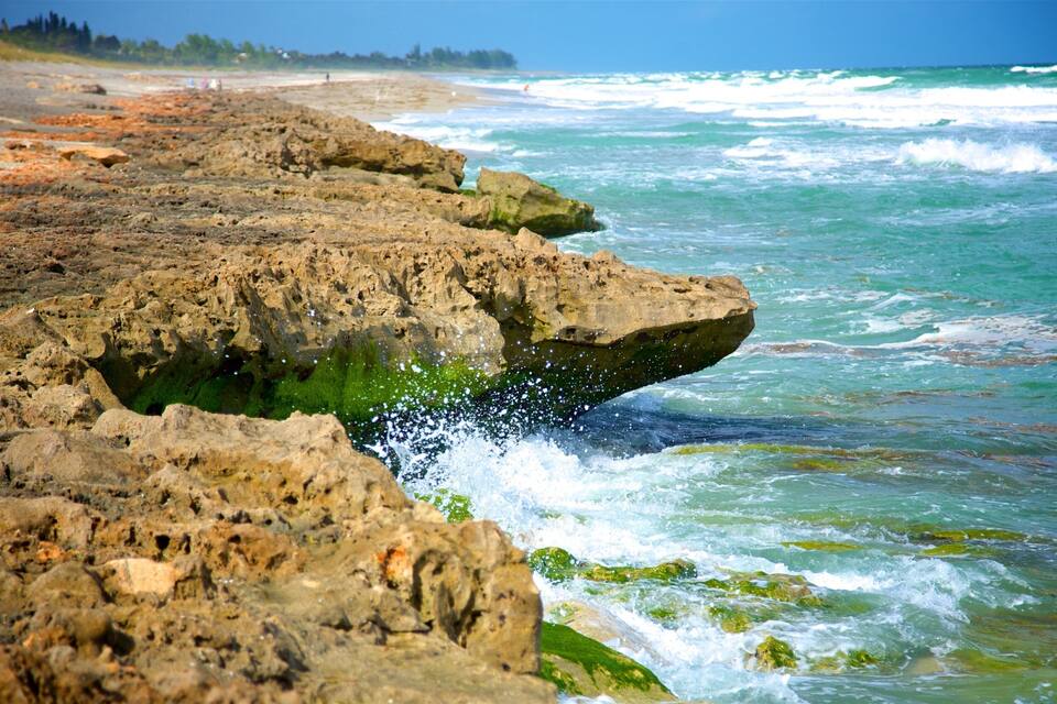Une côte rocheuse où les vagues s’écrasent sur le rivage.