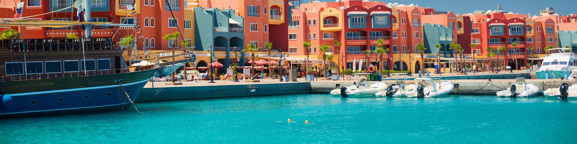 panoramic seascape on colorful Marina promenade street from Red Sea with moored motor yachts. Marina, Hurghada, Egypt