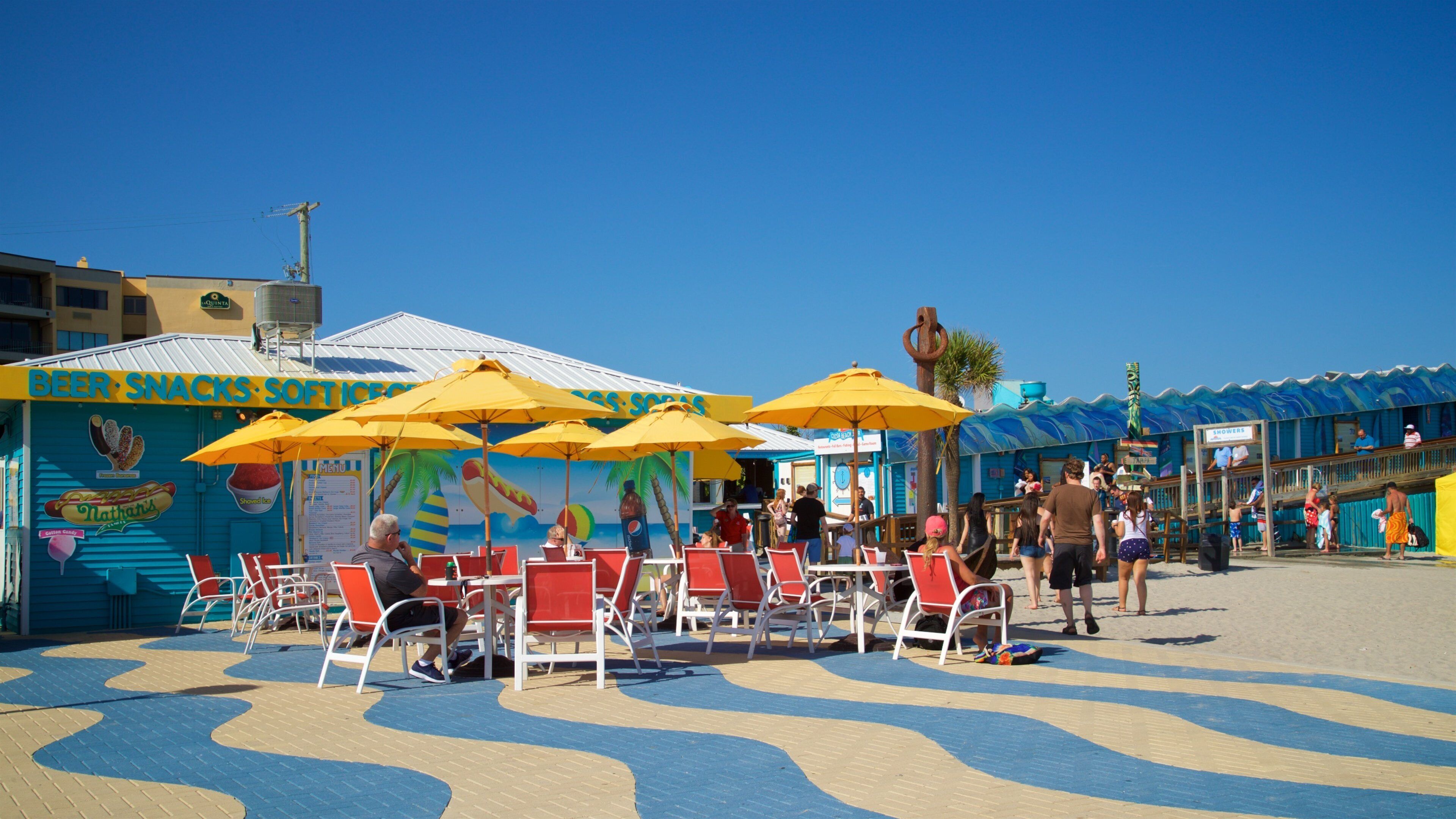 Cocoa Beach Pier which includes a coastal town as well as a small group of people