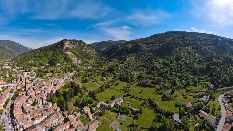 A mountainous landscape with a village nestled in the valley.