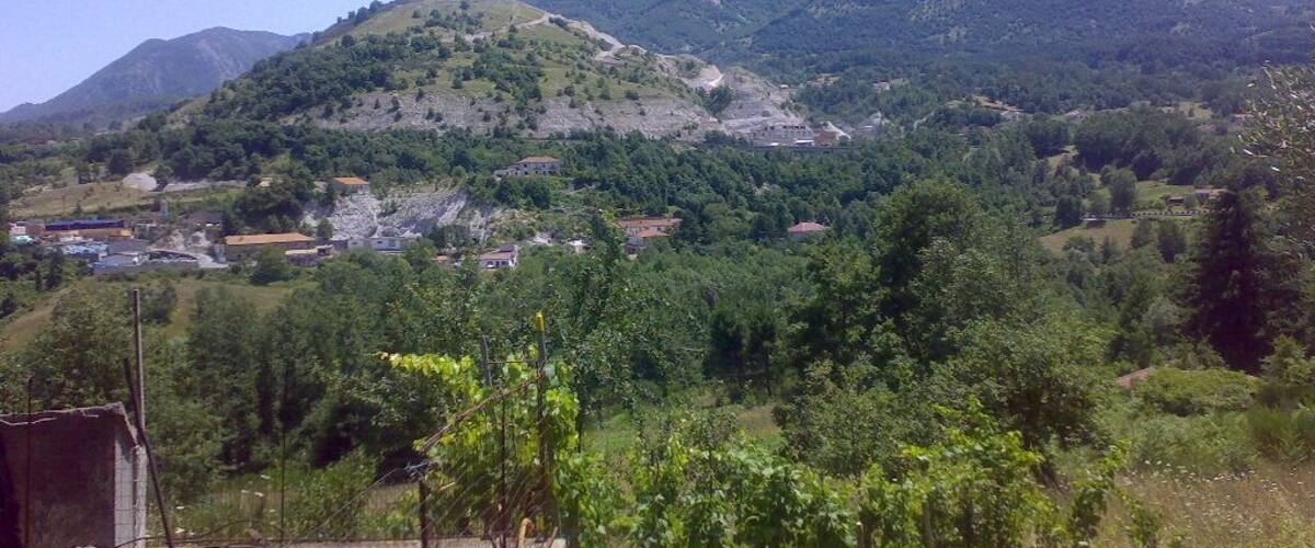 A mountainous landscape with a village nestled in the valley.