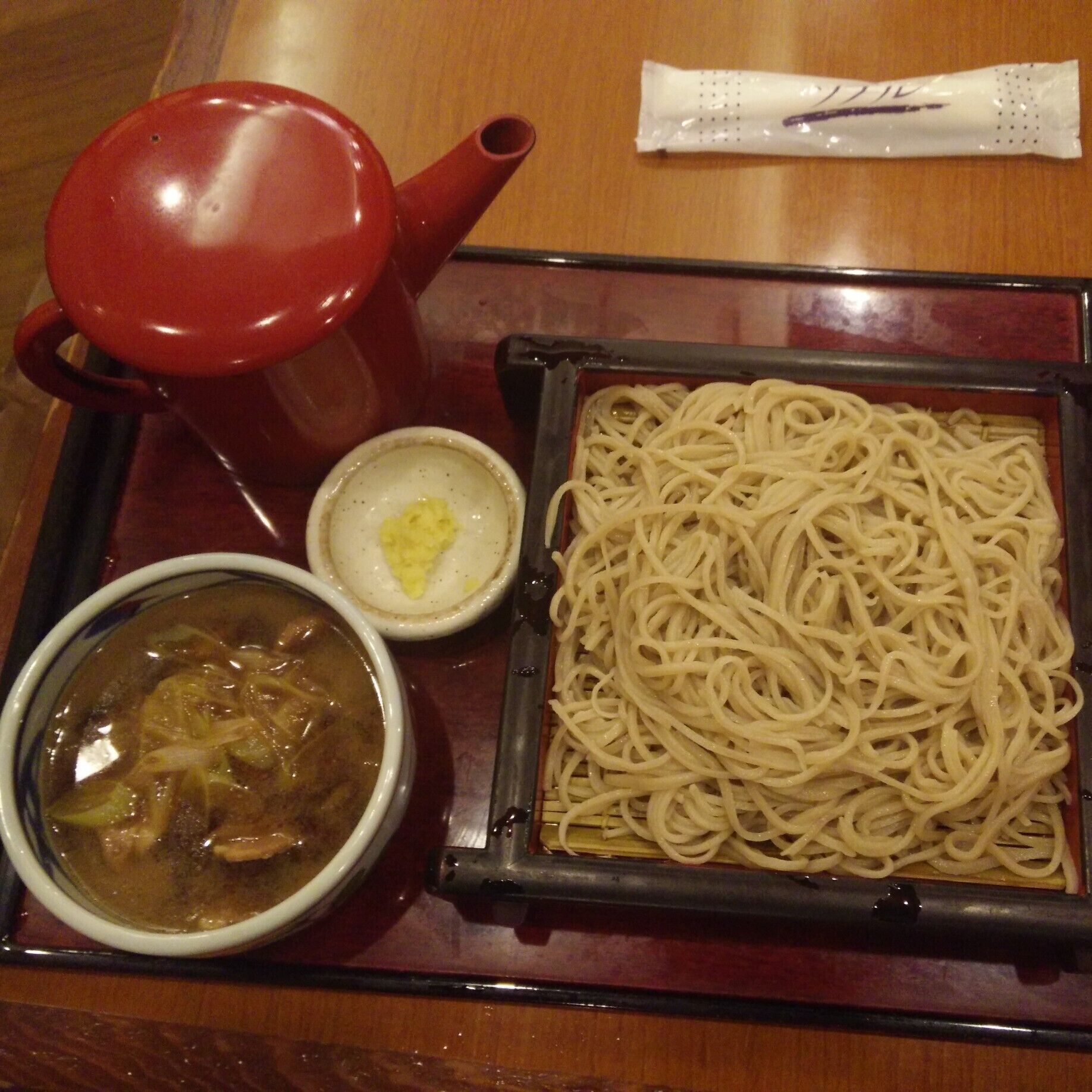 #Nagano is known for #soba so eat soba in Nagano. Simple logic. #ttot #FoodieFinds

From Matsumoto, I had to go back to my friend's place in Gunma with a stop at Nagano. I left the station to find the nearest and highly rated soba shop. Aburaya 油や was on the tabelog list. I ordered the Kamo seiro cold buckweat noodles with duck meat and onion added (literal from the English menu).

It was a lot of soba noodles, as a fat kid, I finished it. The waiter had to come and try to spit out all the English he knows with charades as he saw my clueless face on how to eat it. I knew that I had to dip the noodles on the duck dipping sauce. What I didn't know was to do with the red teapot. I stared at my food for good two minutes and there were two waiters hanging out in the service counter which was on my right side. They probably felt the need to help out this clueless chick.

I am not that educated with soba noodles but I know when the noodles are al dente which they were. The dipping sauce had duck, can't complain because I like duck. It was a nice subtle taste to end the meal with the left over duck sauce with the soup on the teapot.

How to eat soba noodles: You dip noodles on the dipping sauce. Mine was duck, this is probably why I was confused because it wasn't the regular dark dipping sauce. Once finished with noodles, pour teapot soup in the left over sauce then sip sip sip.

https://tabelog.com/en/nagano/A2001/A200101/20000145/
