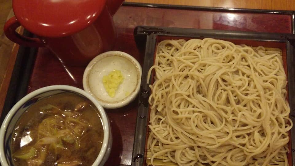 #Nagano is known for #soba so eat soba in Nagano. Simple logic. #ttot #FoodieFinds
From Matsumoto, I had to go back to my friend's place in Gunma with a stop at Nagano. I left the station to find the nearest and highly rated soba shop. Aburaya 油や was on the tabelog list. I ordered the Kamo seiro cold buckweat noodles with duck meat and onion added (literal from the English menu).
It was a lot of soba noodles, as a fat kid, I finished it. The waiter had to come and try to spit out all the English he knows with charades as he saw my clueless face on how to eat it. I knew that I had to dip the noodles on the duck dipping sauce. What I didn't know was to do with the red teapot. I stared at my food for good two minutes and there were two waiters hanging out in the service counter which was on my right side. They probably felt the need to help out this clueless chick.
I am not that educated with soba noodles but I know when the noodles are al dente which they were. The dipping sauce had duck, can't complain because I like duck. It was a nice subtle taste to end the meal with the left over duck sauce with the soup on the teapot.
How to eat soba noodles: You dip noodles on the dipping sauce. Mine was duck, this is probably why I was confused because it wasn't the regular dark dipping sauce. Once finished with noodles, pour teapot soup in the left over sauce then sip sip sip.
https://tabelog.com/en/nagano/A2001/A200101/20000145/