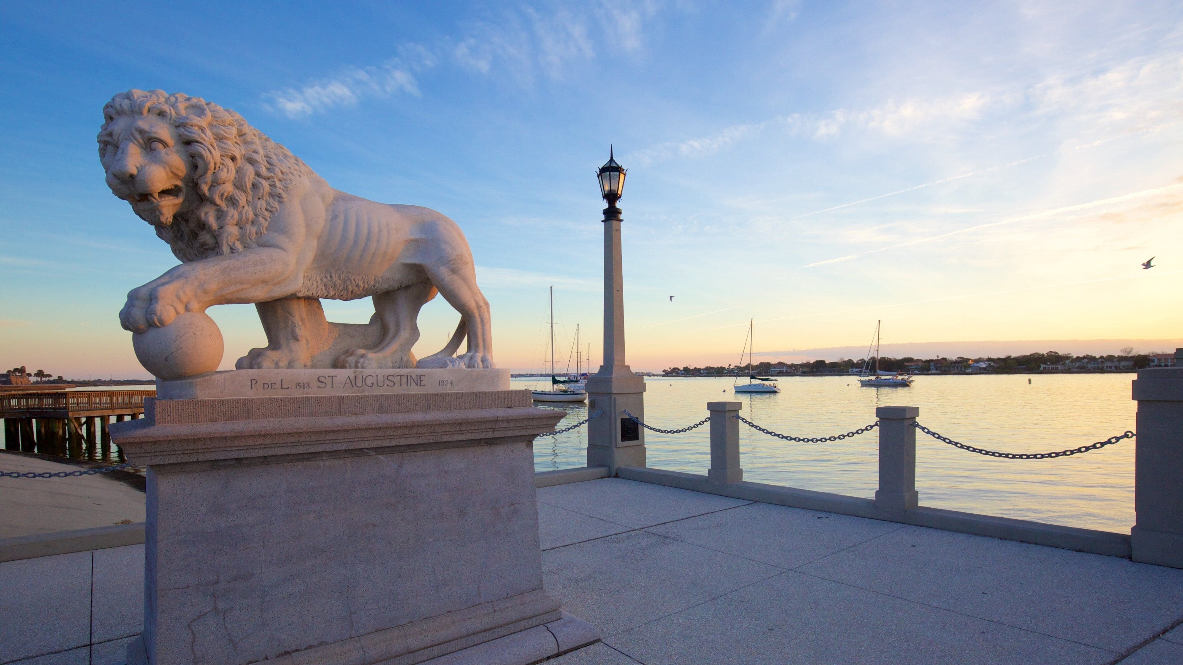 Bridge of Lions som inkluderer statue eller skulptur, solnedgang og kyst