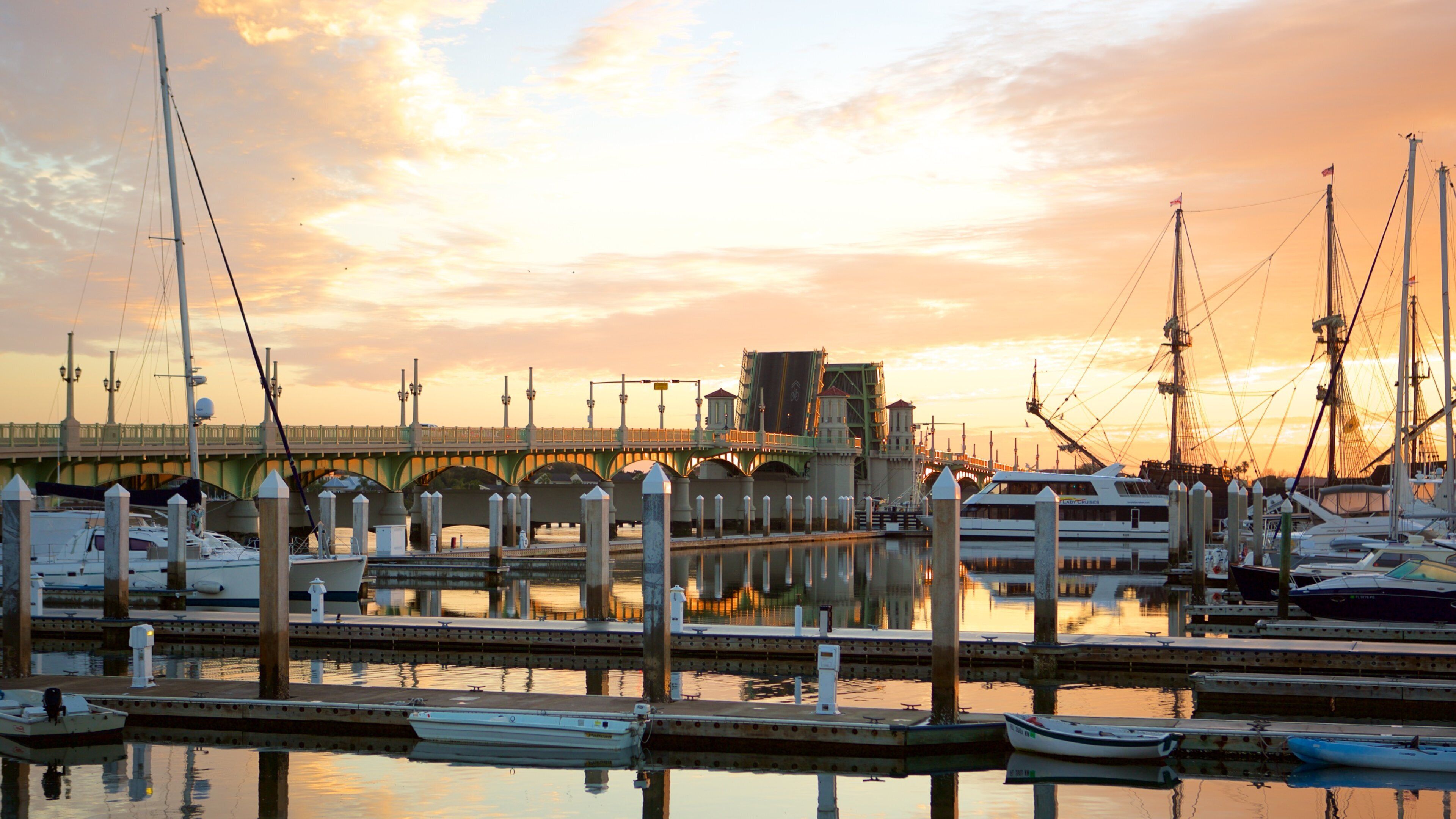 Bridge of Lions featuring boating, sailing and a sunset