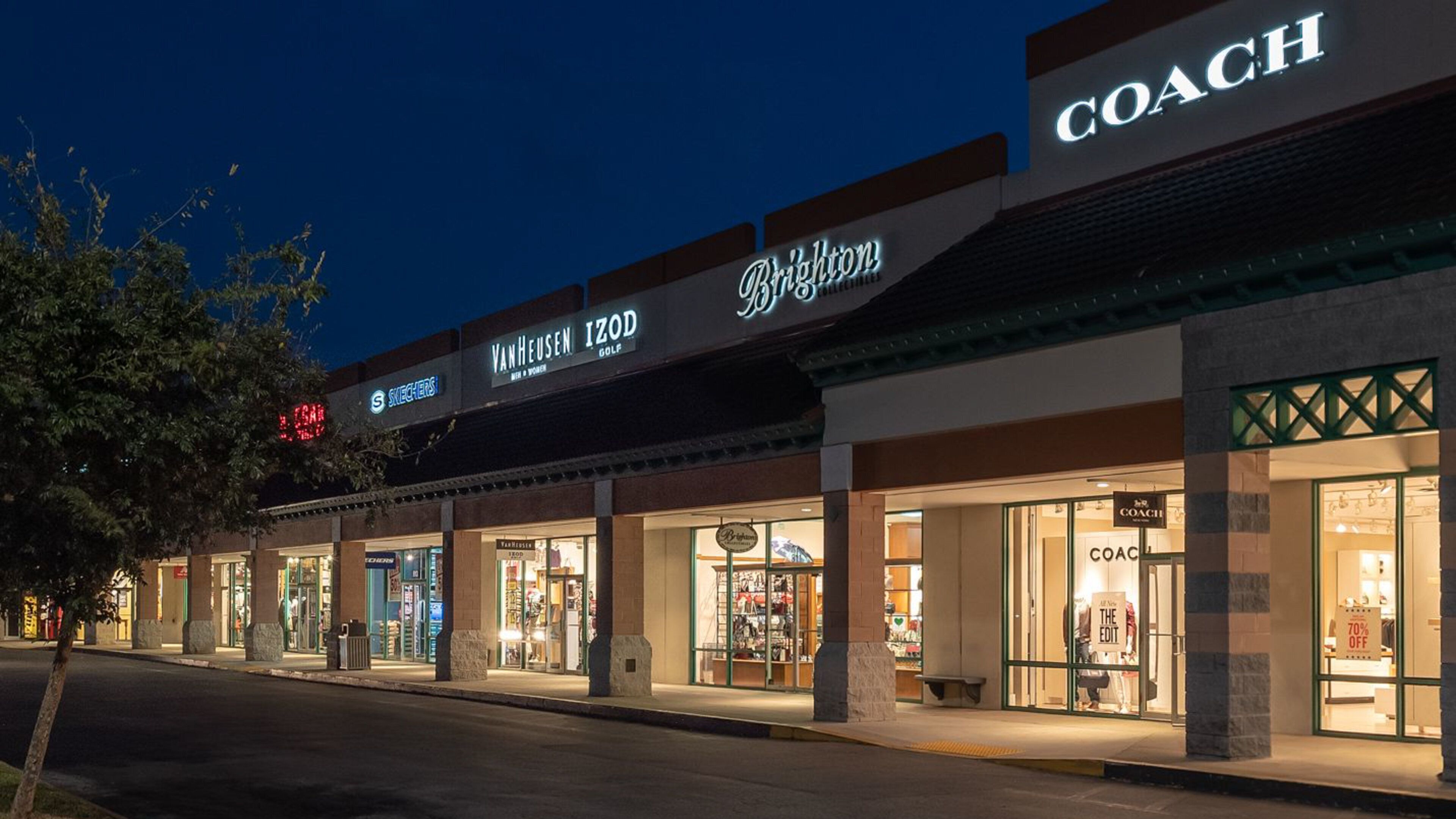 St. Augustine Premium Outlets which includes signage, night scenes and shopping