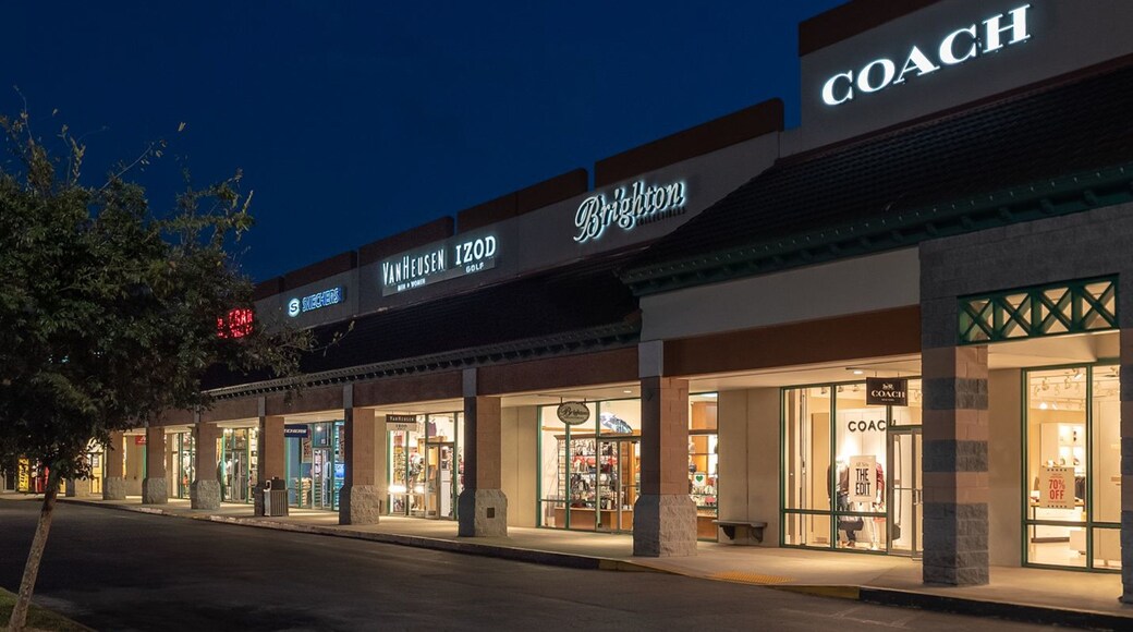 St. Augustine Premium Outlets which includes signage, night scenes and shopping