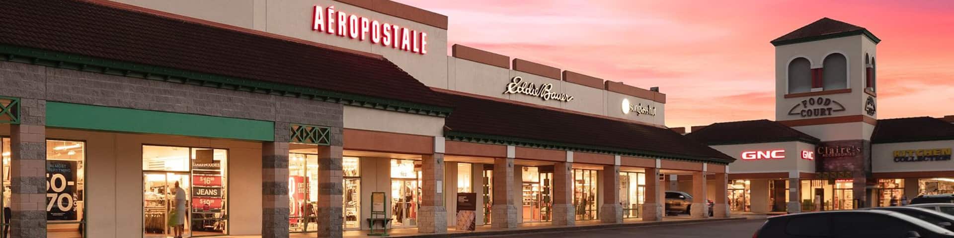 St. Augustine Premium Outlets which includes signage, shopping and a sunset