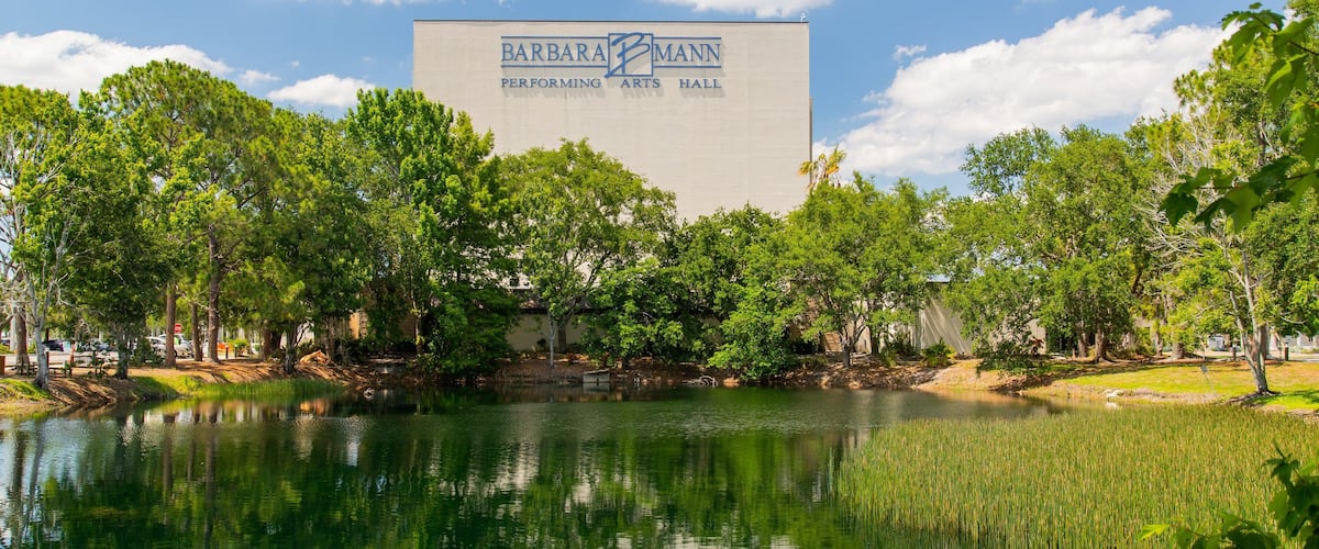 Barbara B Mann Hall featuring a pond