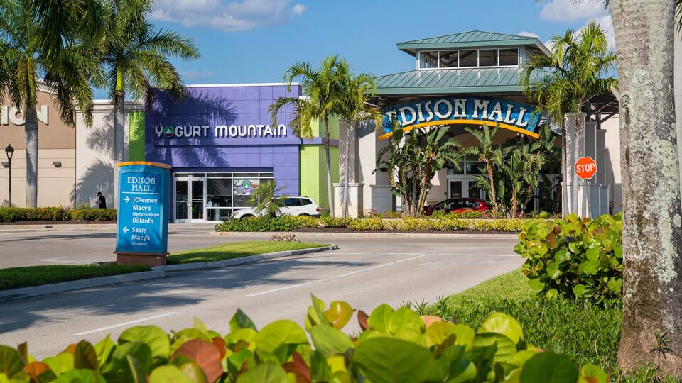A shopping mall entrance with a sign for Edison Mall and nearby stores.