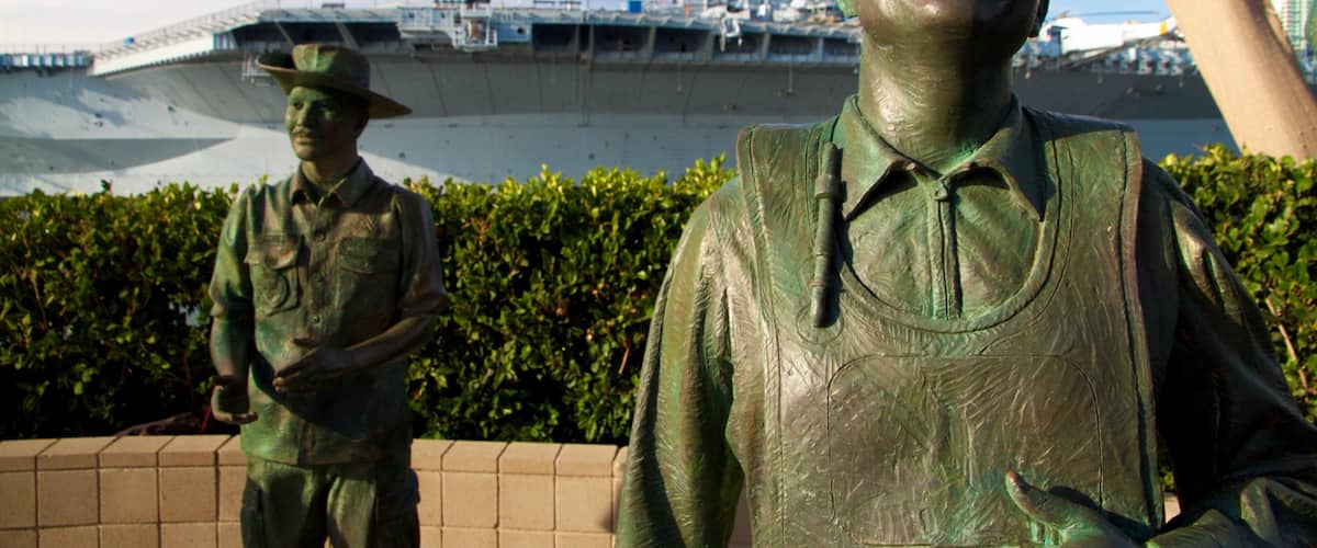 Navy Pier which includes a statue or sculpture, military items and a marina