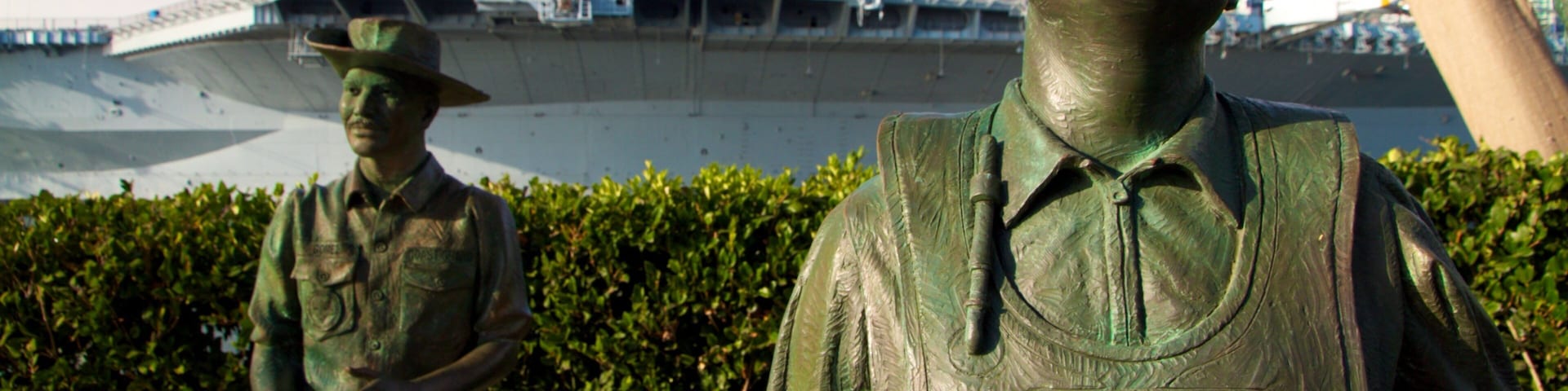 Navy Pier which includes a statue or sculpture, military items and a marina