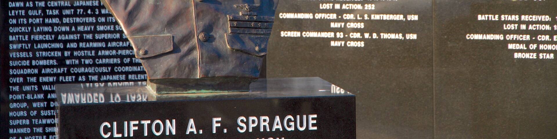 Navy Pier showing a memorial, a statue or sculpture and military items