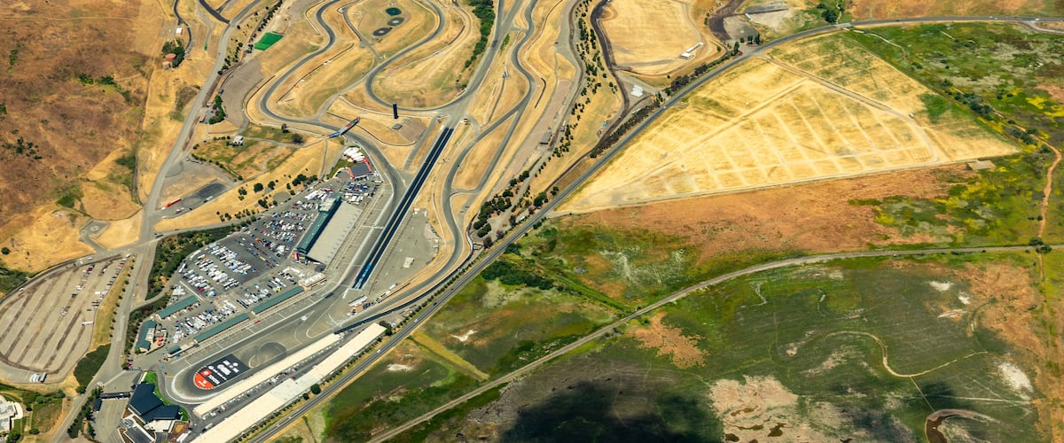 Aerial view of Sonoma Raceway in the golden grass fields and vinyards of wine country