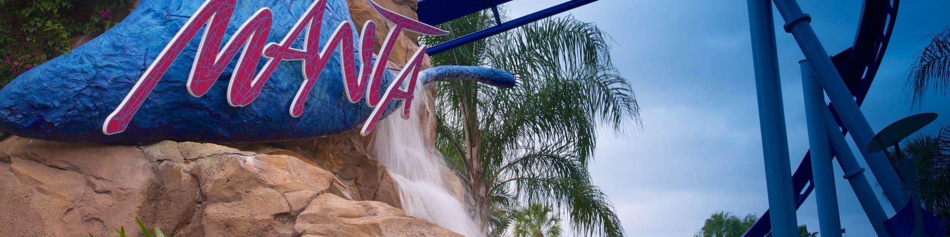 A roller coaster at an amusement park with a large sign reading "MANTA".