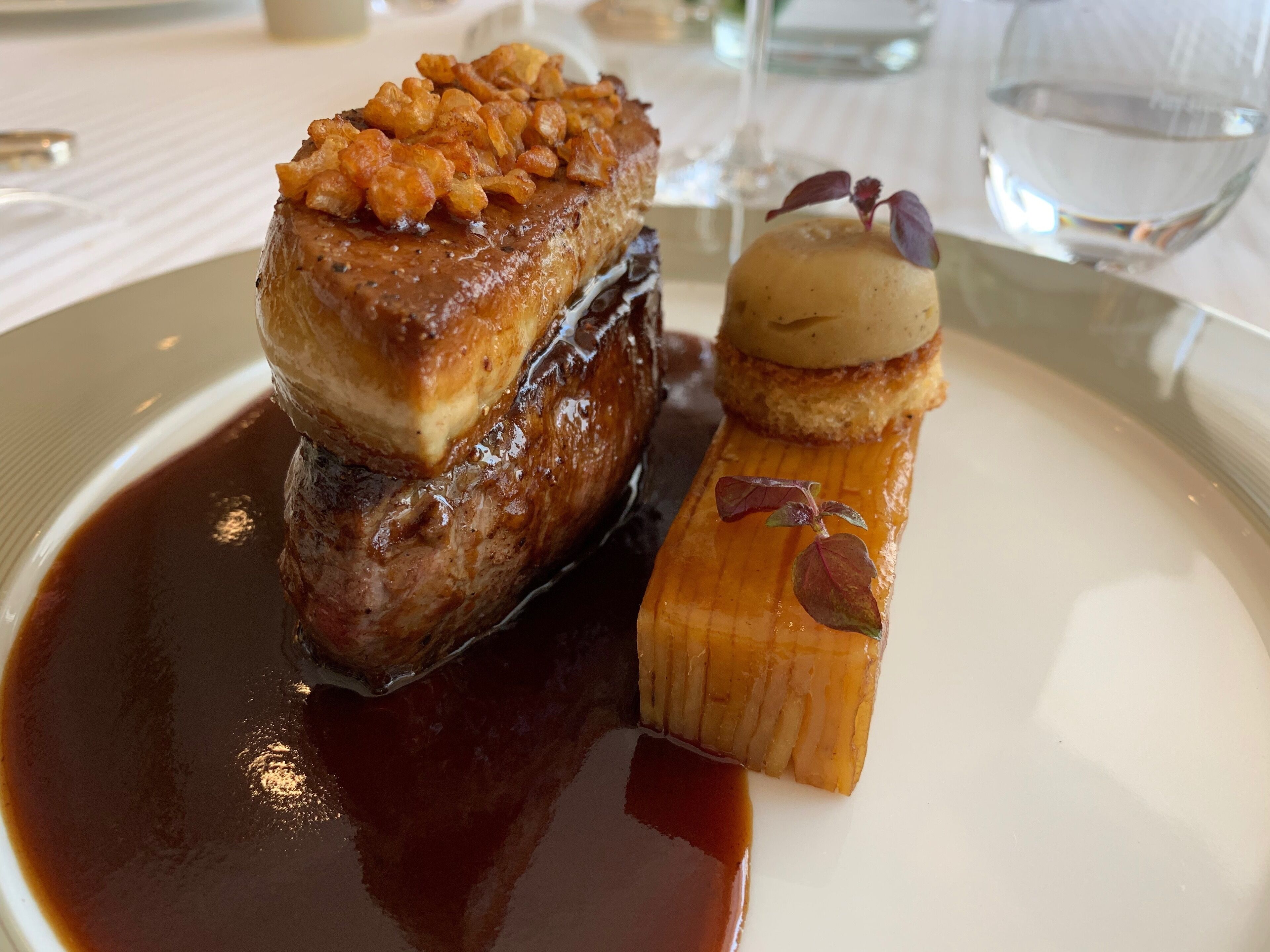 A dessert with caramelized fruit on top and a caramelized banana.