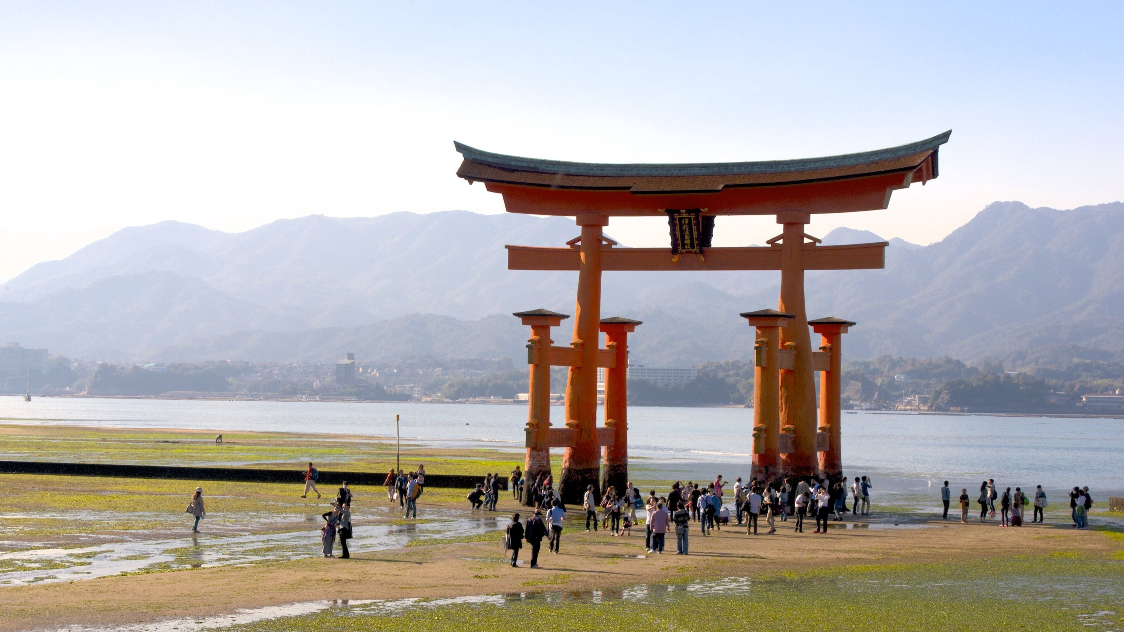 Hiroshima featuring heritage elements and a lake or waterhole as well as a large group of people