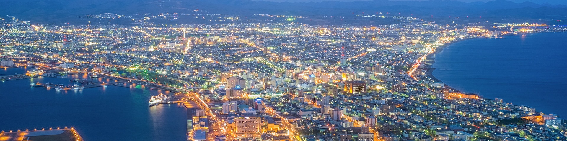 Beautiful twilight of Hakodste's cityscape night view from Hakodate mountain in winter season. Scenery of famous tourist view point in bird eye's view, one of many popular places in Hokkaido, Japan.;