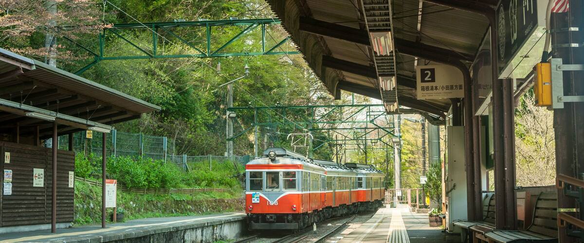 Hakone, Japan, April 2018. The Hakone Tozan train arriving at station in Hakone, Japan. Red nostalgic train at beautiful Hakone station, no people.