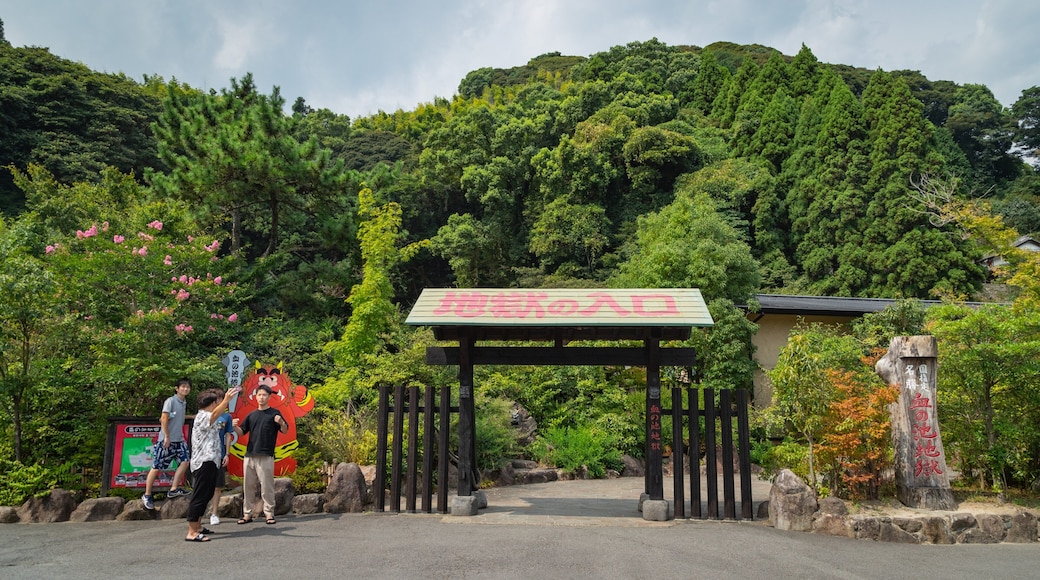 Oita which includes a garden and signage as well as a small group of people