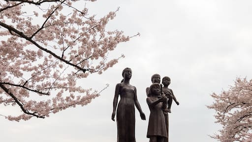 Family statue at Takamatsu Park surrounded by cherry blossoms (sakura) in spring, Morioka, Japan.