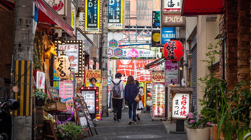 Kobe showing street scenes and signage as well as a couple