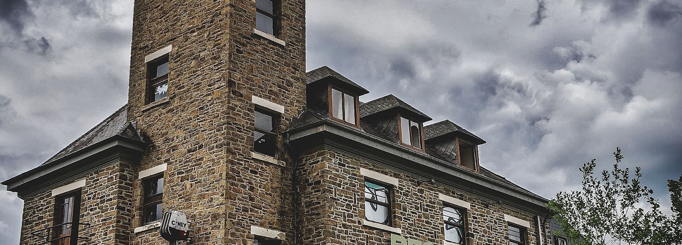 A historic building with a tower and a restaurant sign.