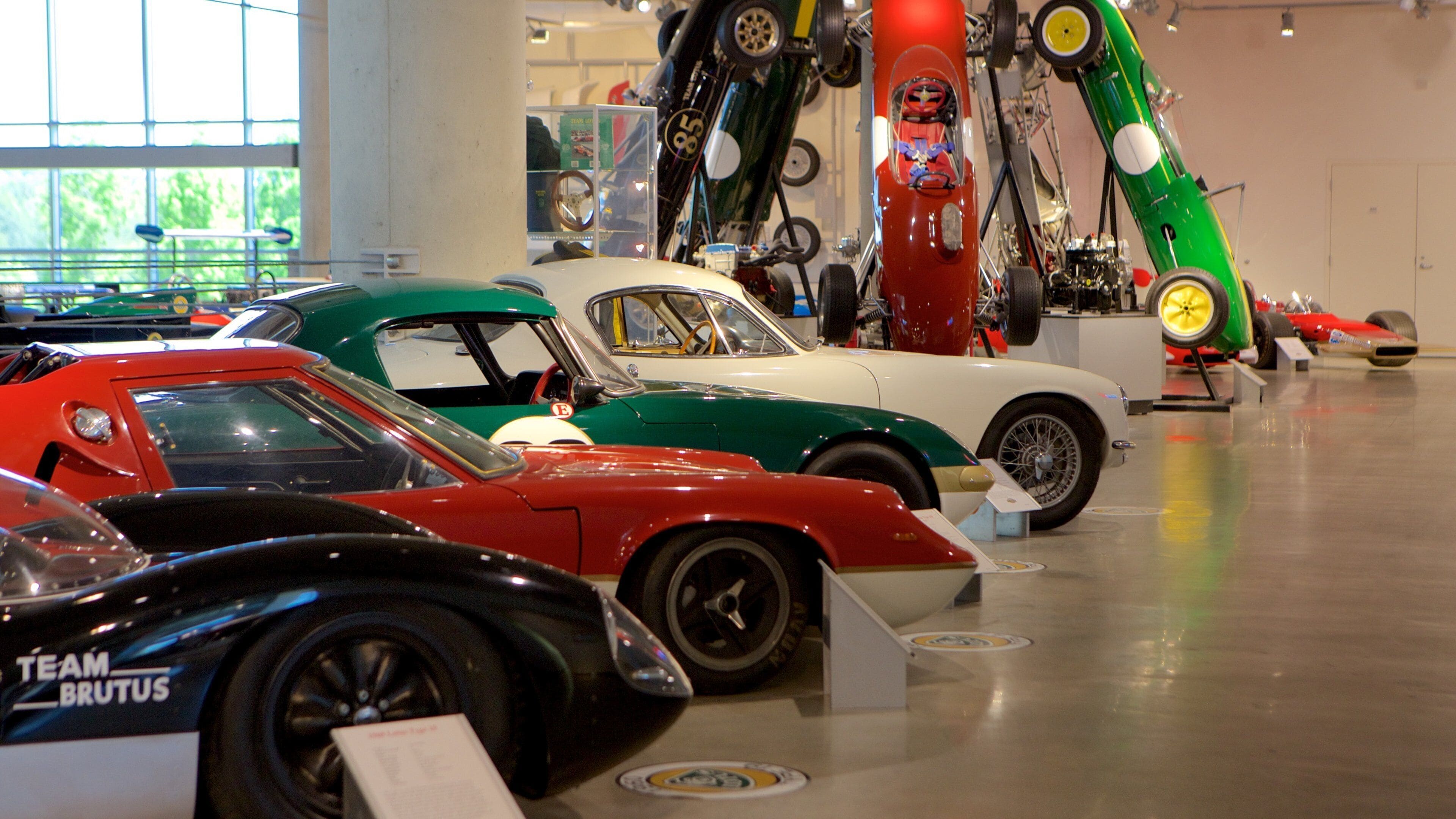 Vintage racing cars on display in a museum.