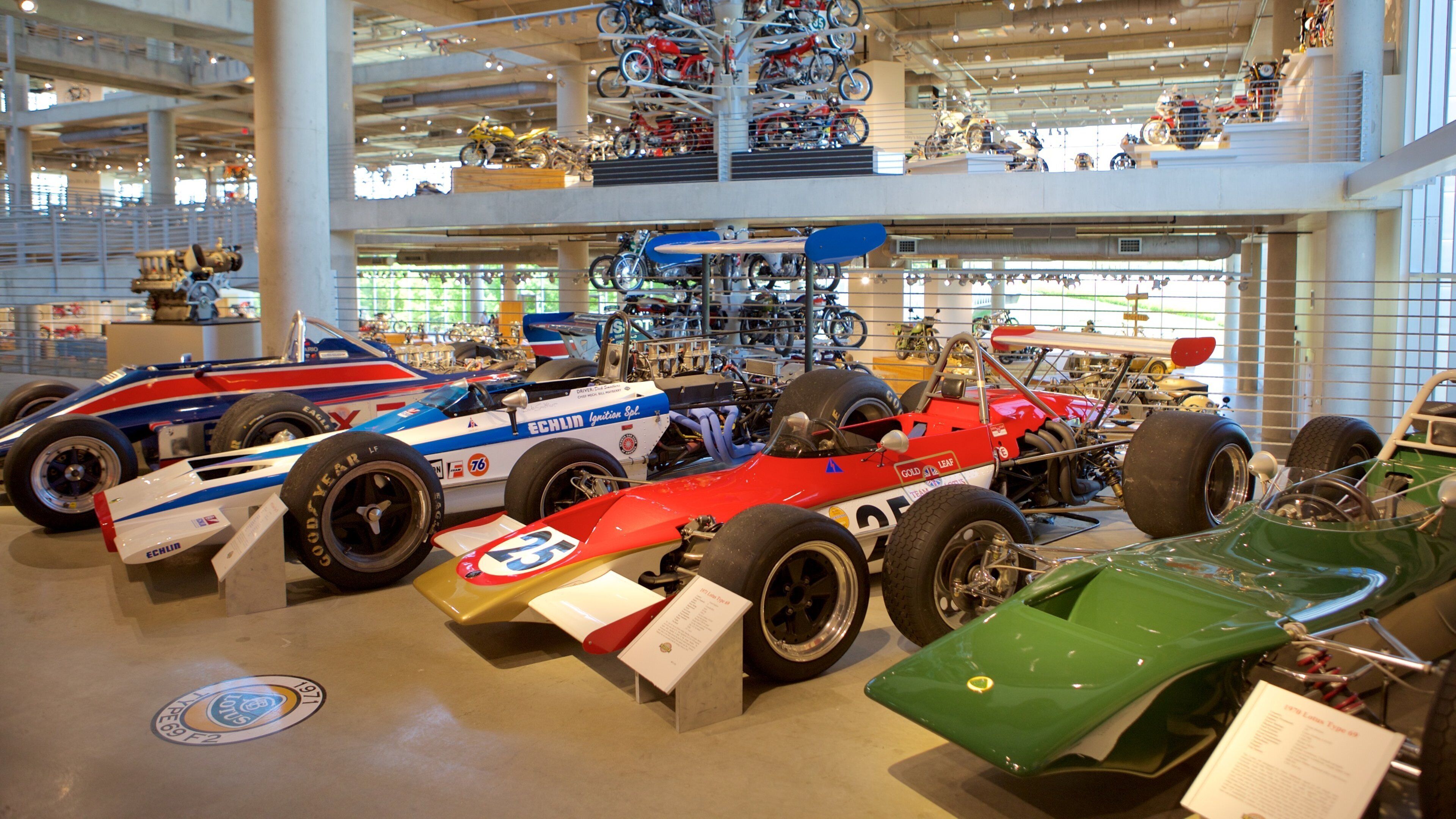 A museum with various racing cars on display.