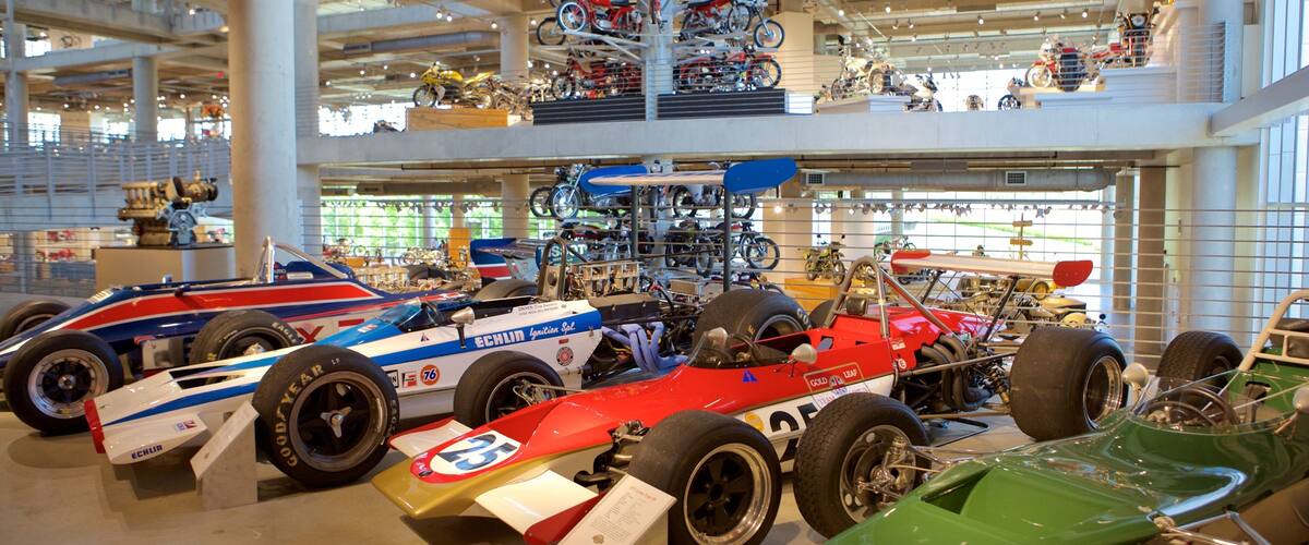 A museum with various racing cars on display.
