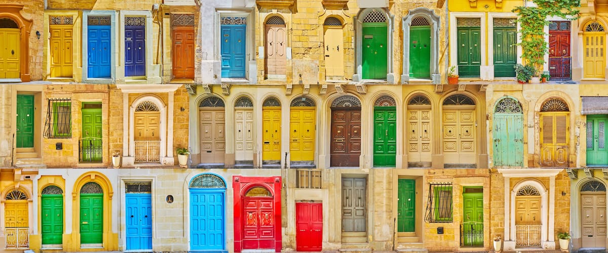 A row of colorful doors on a building facade.