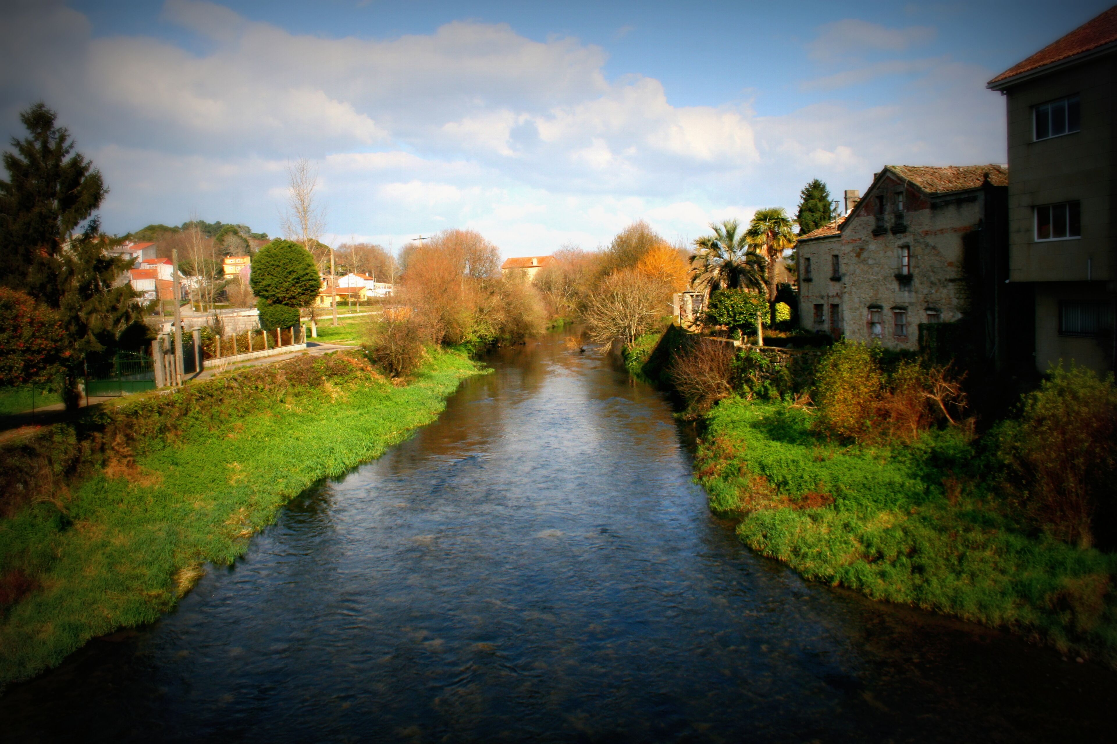 A river flowing through a town with buildings on both sides.